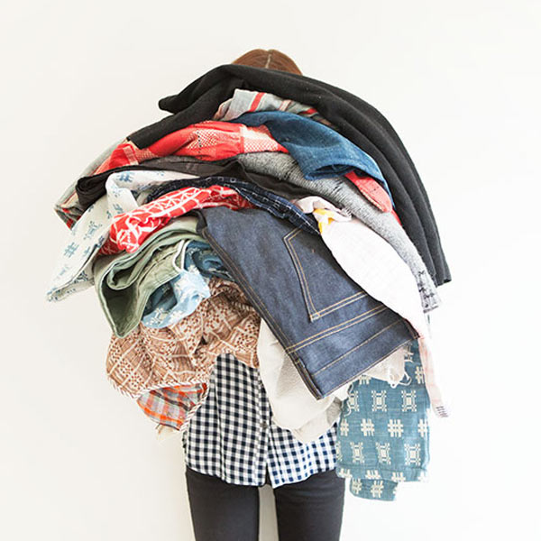photo of person holding pile of clothes
