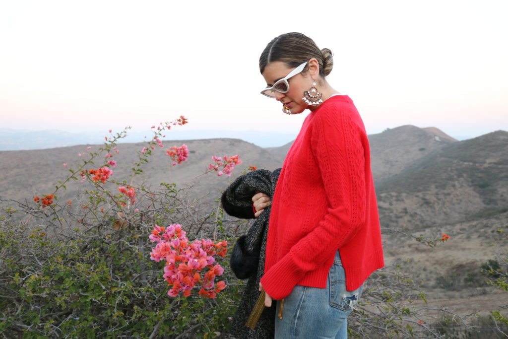 Mary Elizabeth in a red sweater outdoors