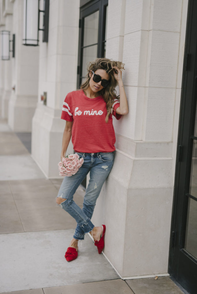 Woman wearing a red Valentine's Day themed shirt.