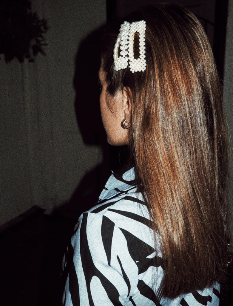 Blogger wearing hair clip with pearls.