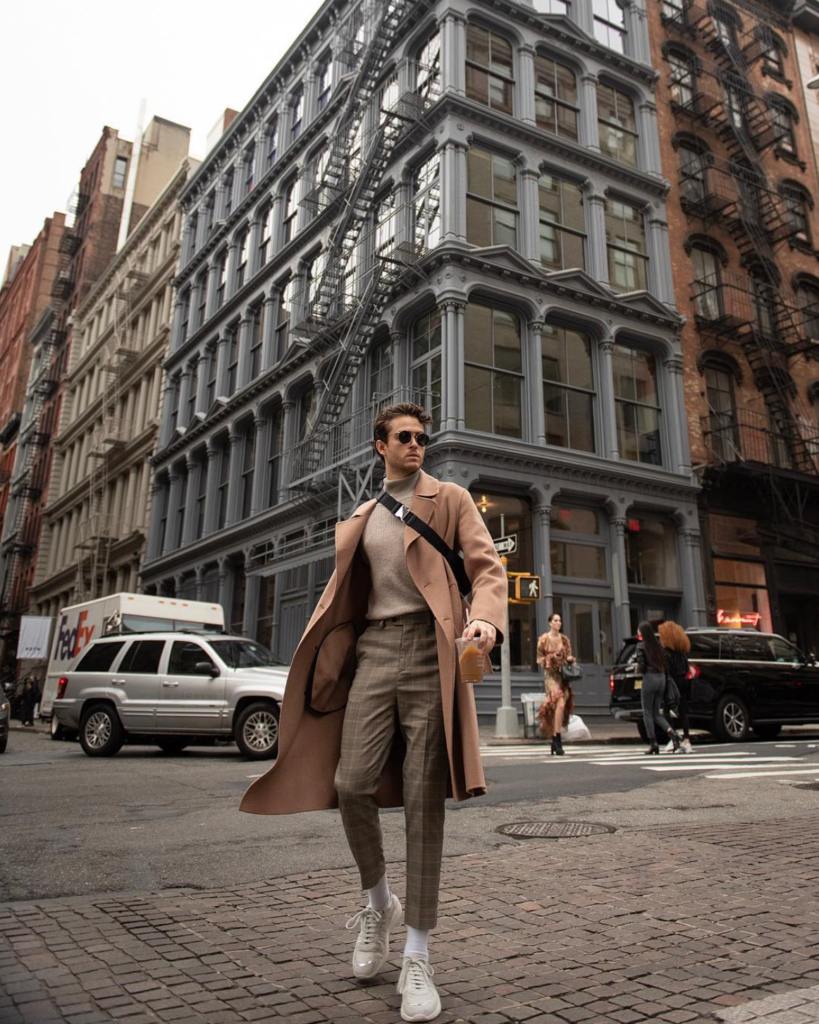 Adam in the street wearing brown pieces.