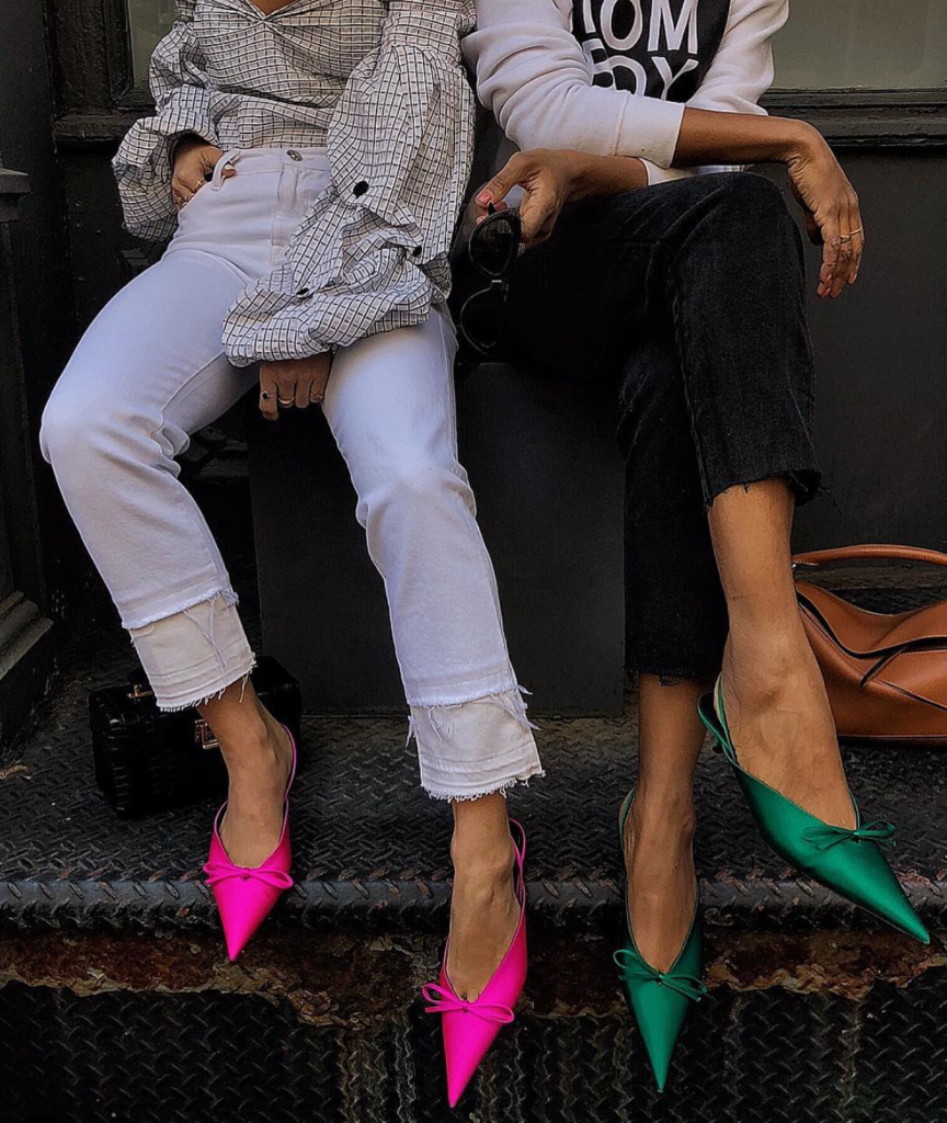 Women wearing bright neon heels with subtle outfit.