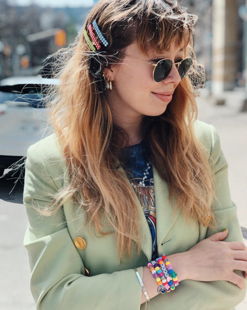 Woman wearing beaded accessories and hair clips.