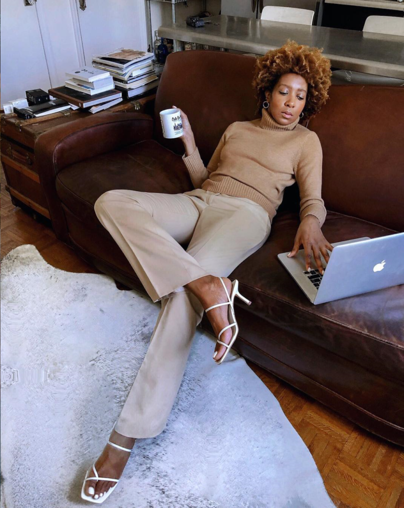 Woman on couch with heeled sandals.