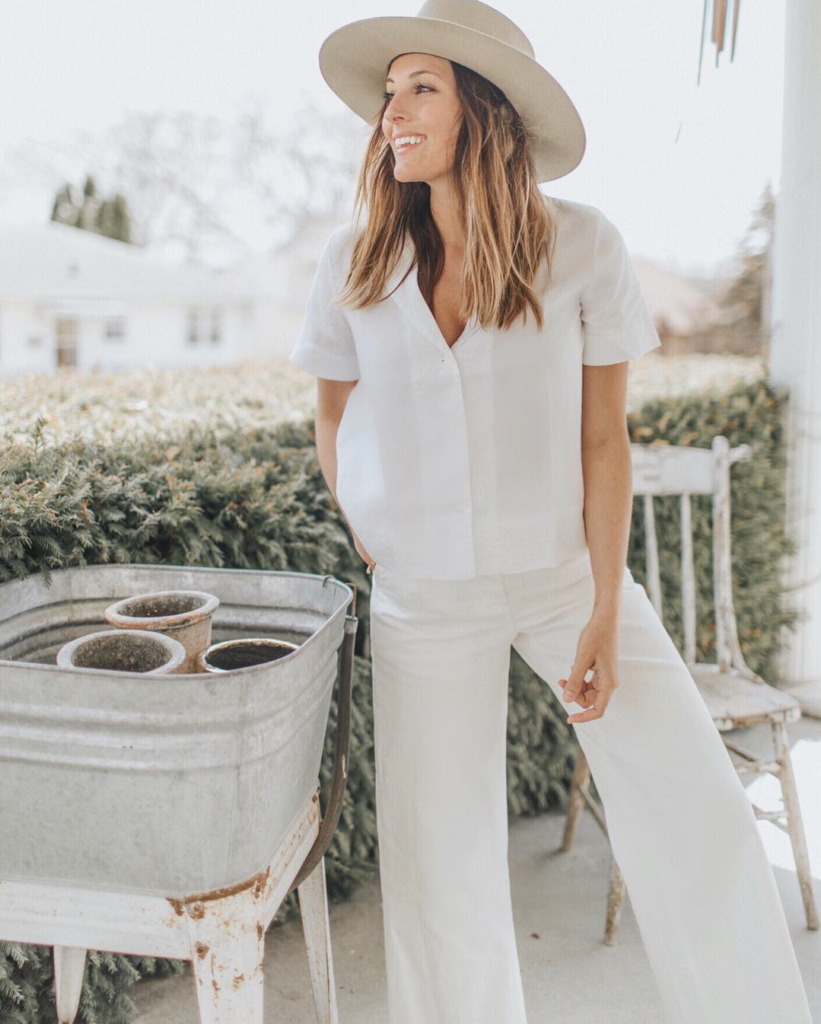 Woman in all-white sustainable wardrobe.