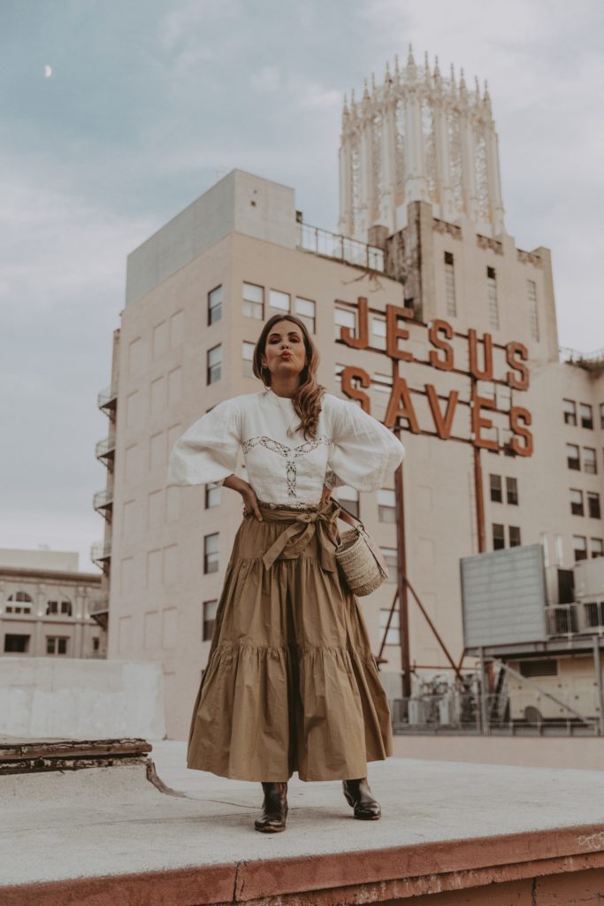 Woman wearing a maxi skirt on a rooftop.