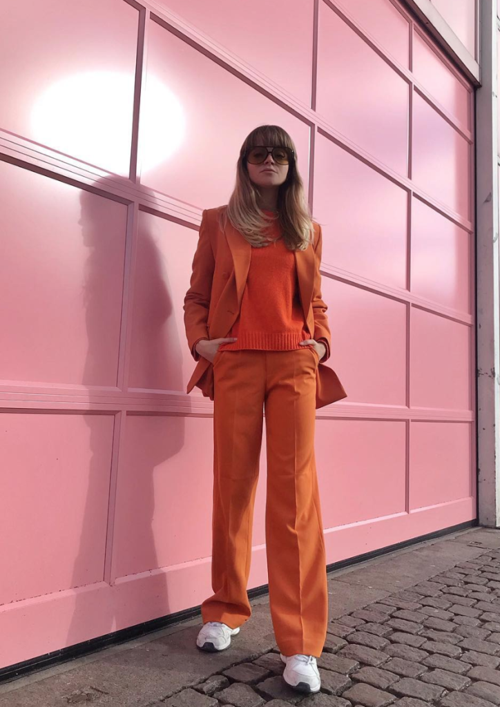 Woman wearing monochromatic orange outfit.