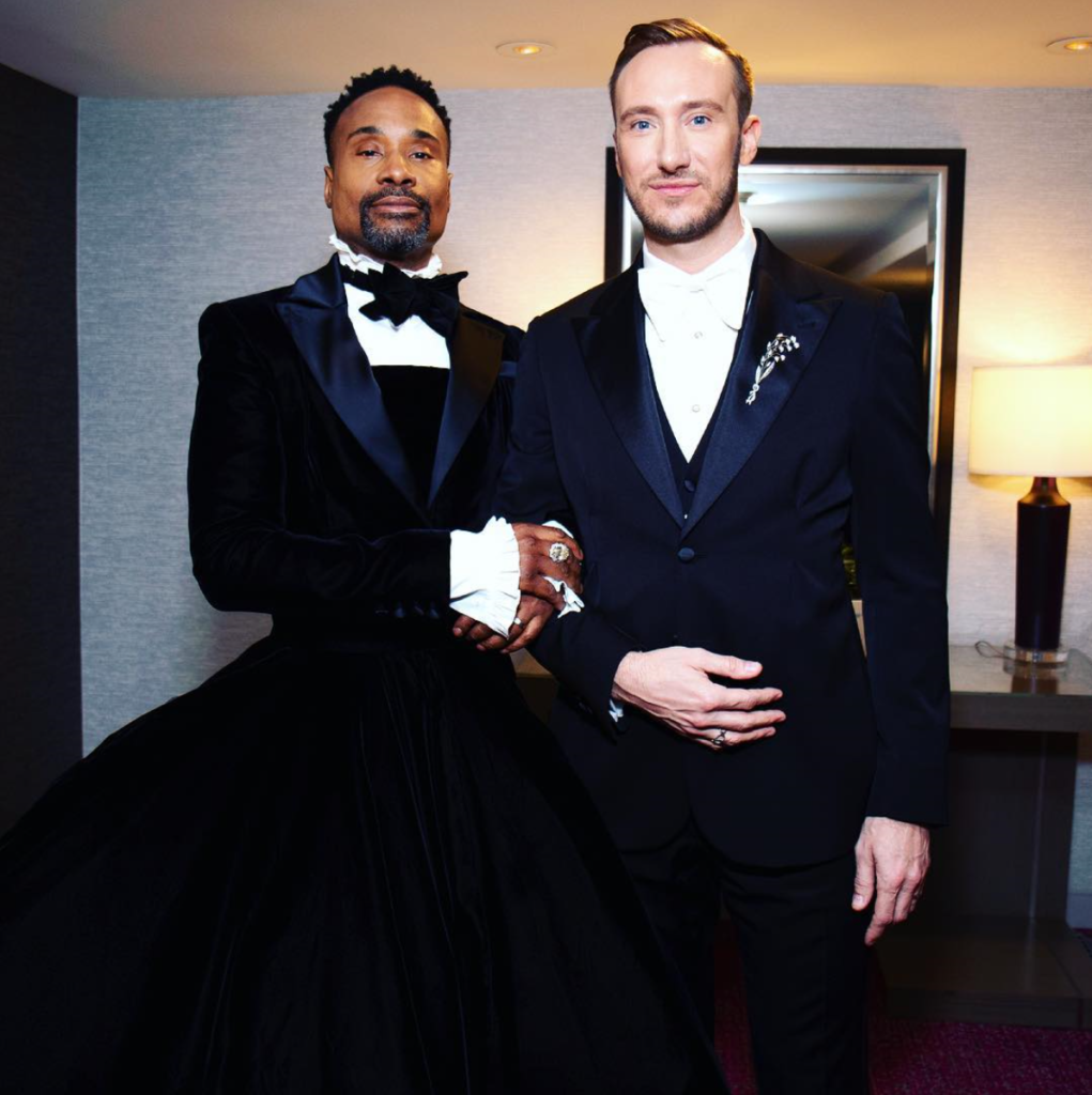 Billy Porter and guest in tuxedo.