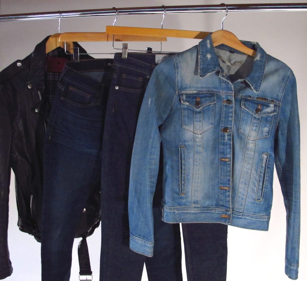 Different types of denim and leather jacket hanging for selling.