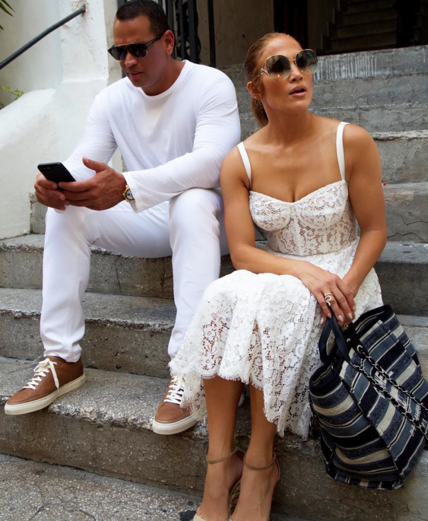 Celebrity couple wearing white on European steps.