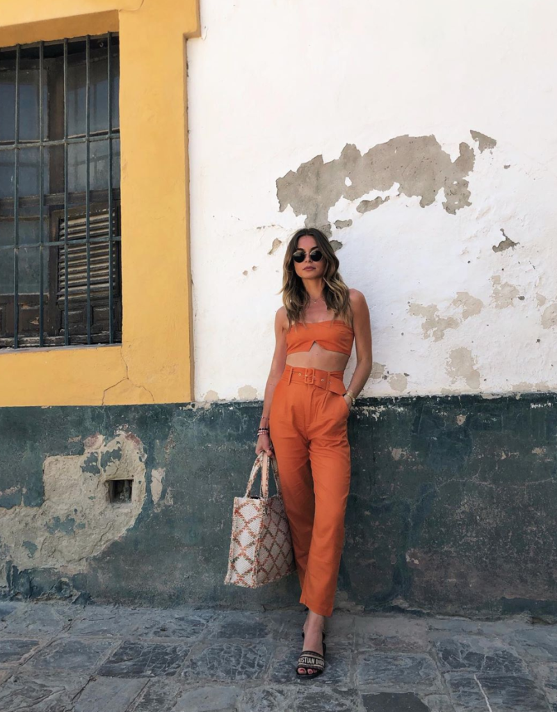 Woman in two piece full orange outfit.