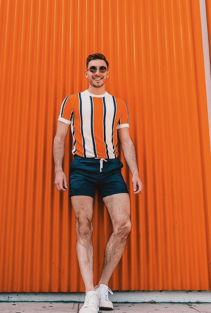 Man wearing orange striped short with shorts.