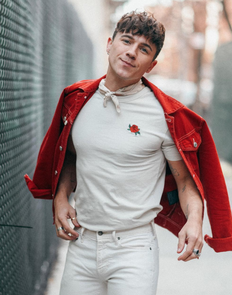 Blogger wearing an all-white outfit with red jacket.