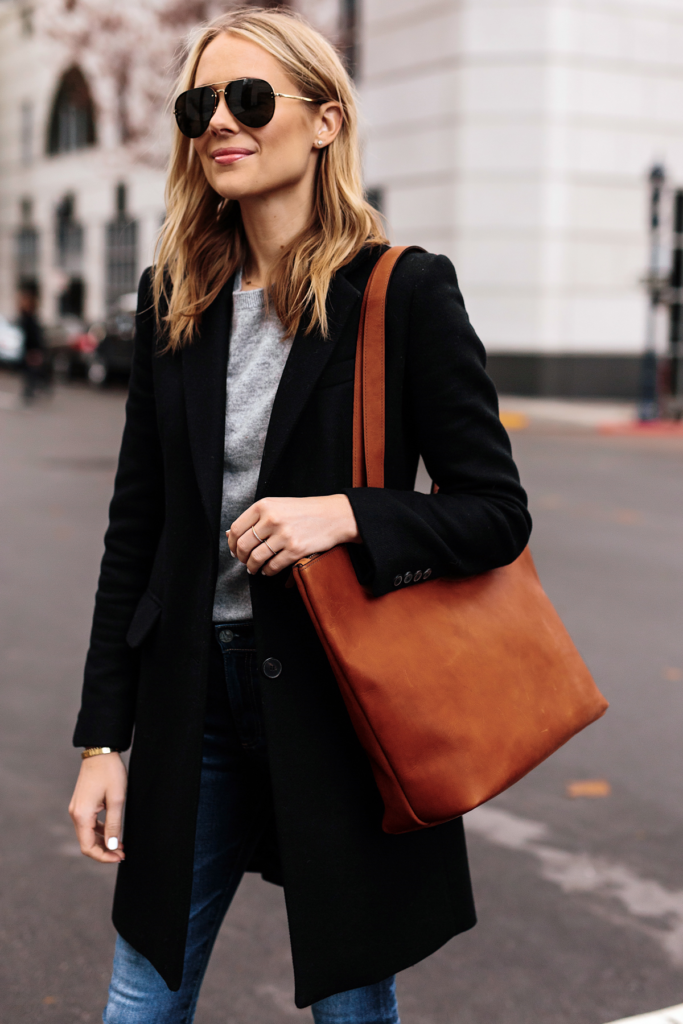 Photo of a woman wearing a well made brown tote bag.