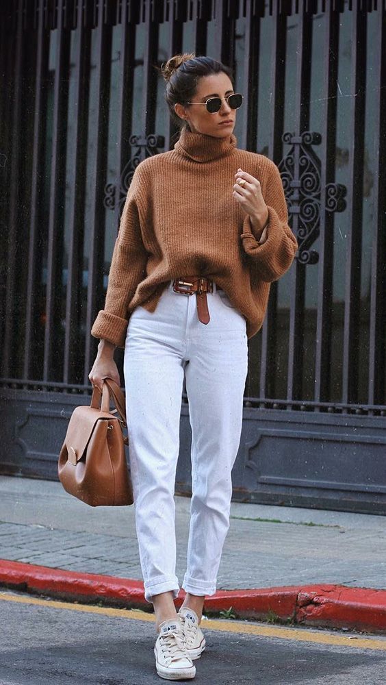 Woman wearing white pants and a brown knit sweater for Labor Day ideas.