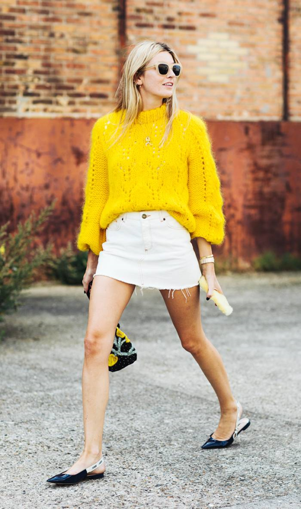 Woman wearing white skirt with bright yellow sweater as a Labor Day idea.