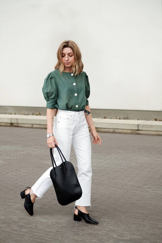 Woman wearing green shirt with white pants.