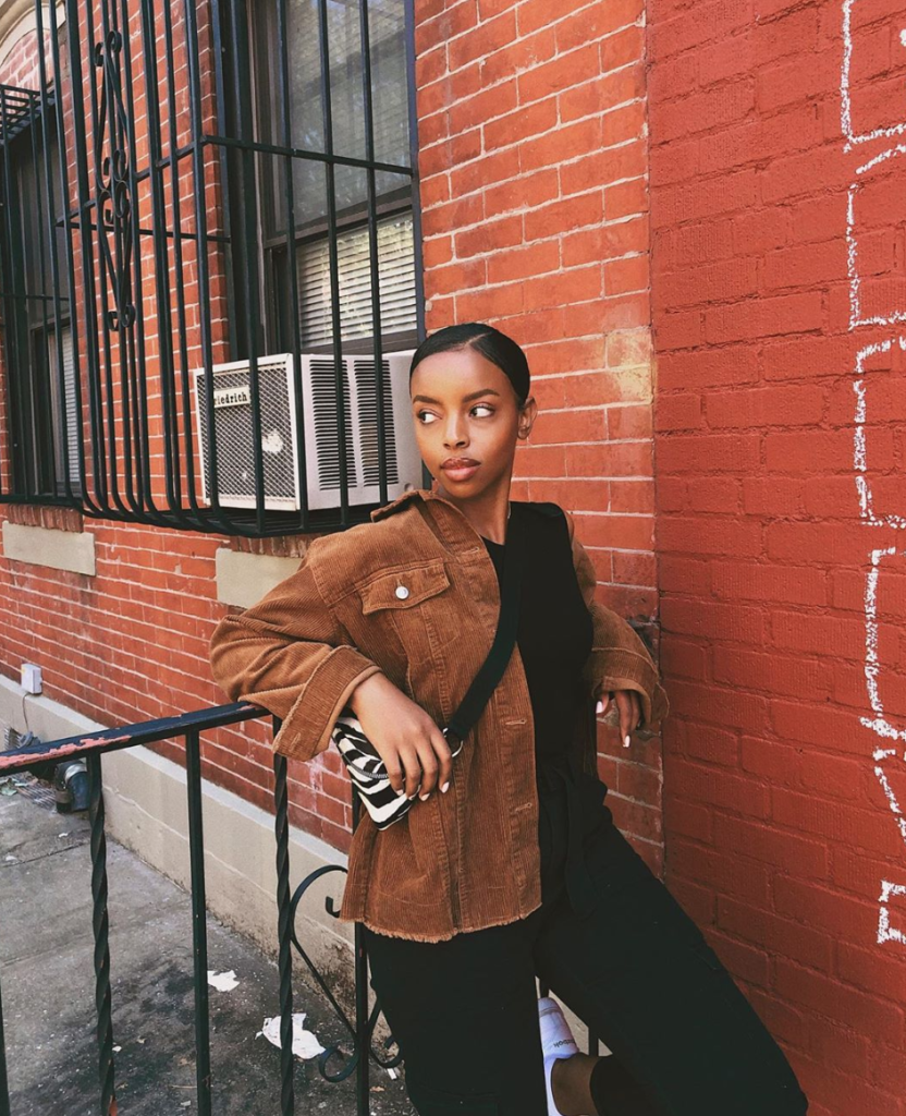 Woman in 90's style brown corduroy jacket.