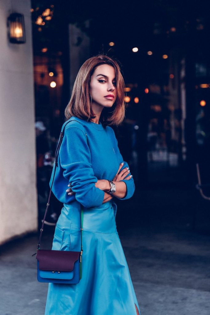 Woman wearing different blue hues for monochromatic look.