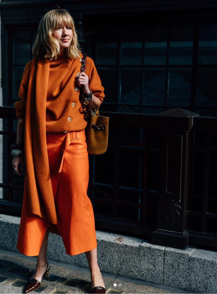 Model mixing orange textures for a monochromatic look.