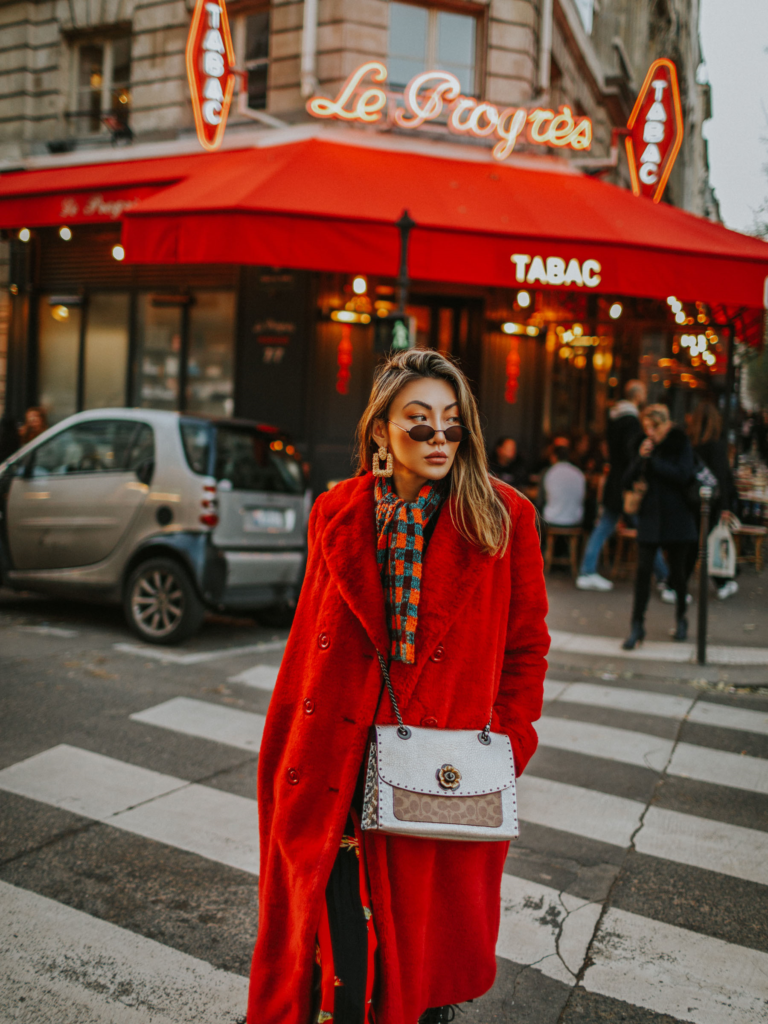Blogger wearing ruby red jewel tone overcoat.