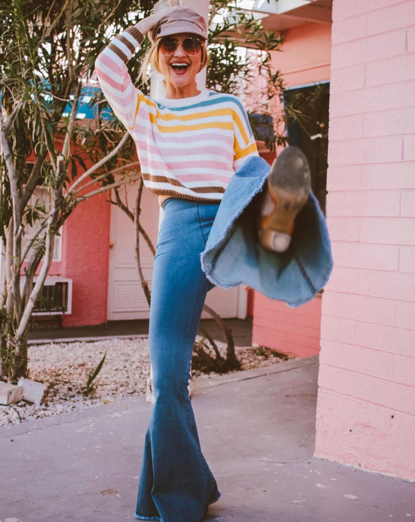 Blogger pairing denim with colorful striped top.
