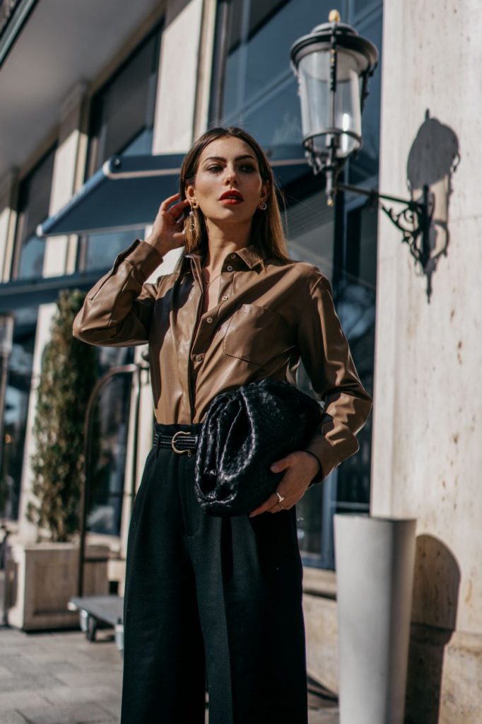 Woman brown button up and flowing trousers.