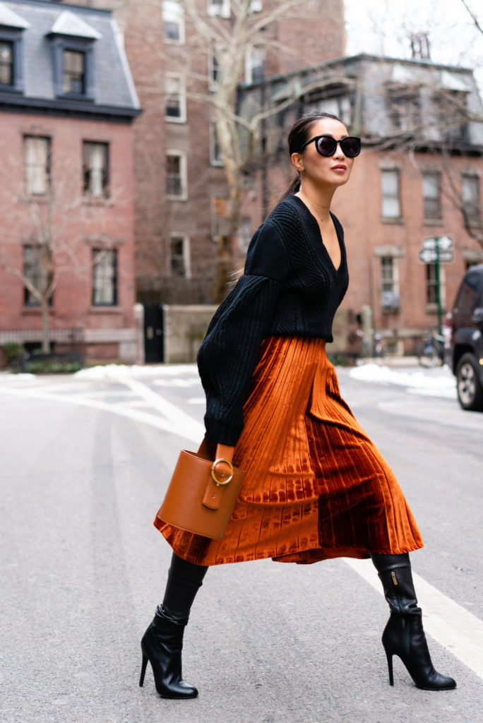 Blogger wearing an orange velvet skirt for the holiday season.