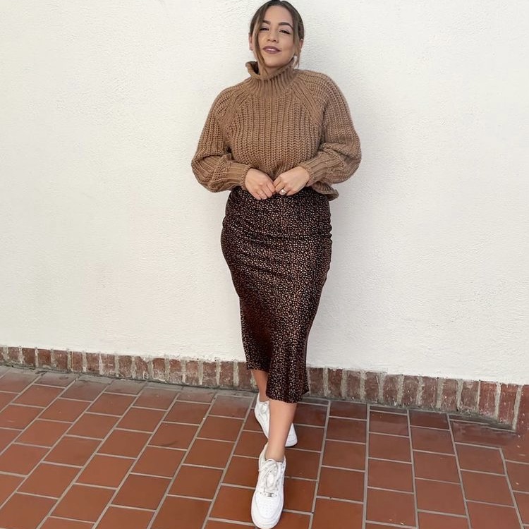 Women in turtleneck sweater and skirt