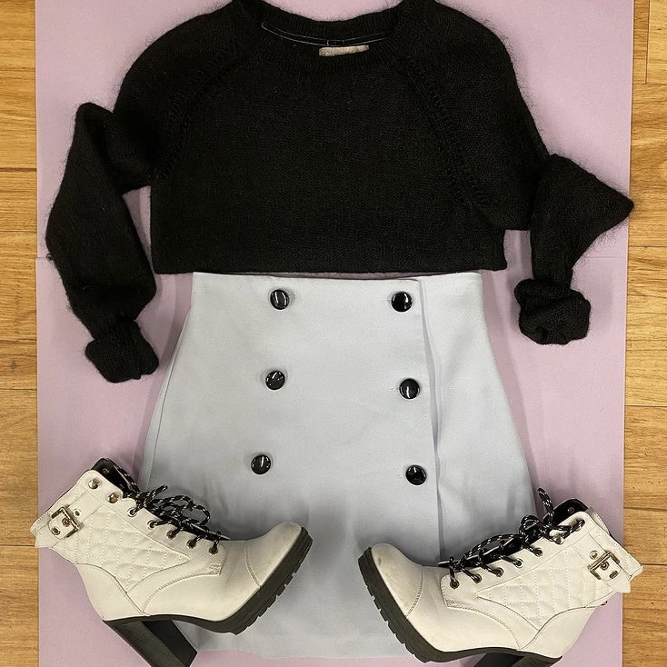 Black sweater with white skirt and boots
