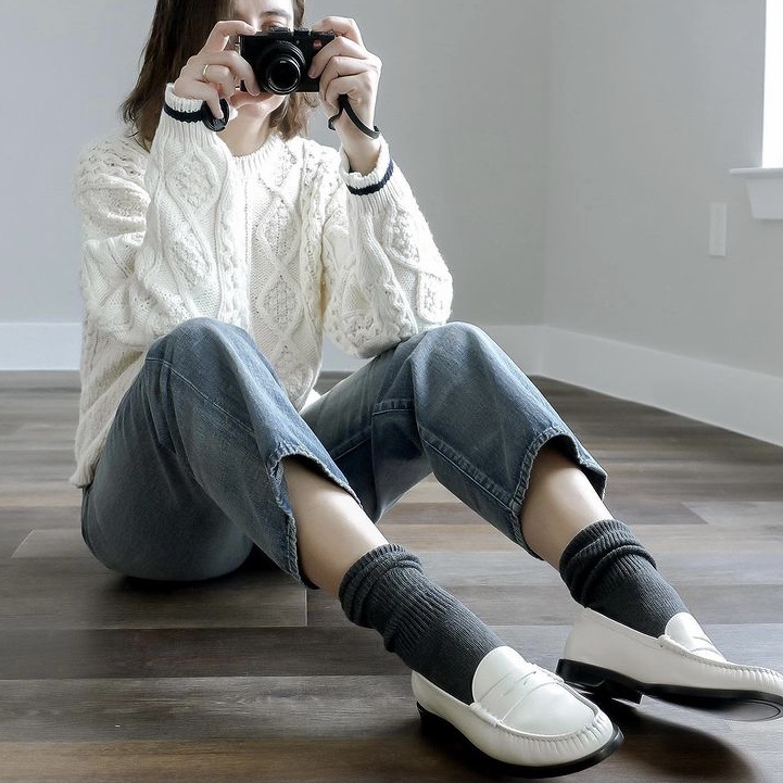 Photo of woman wearing loafers with socks