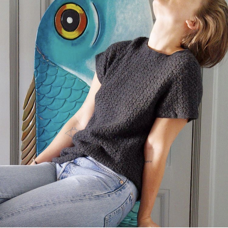 photo of woman in crochet t-shirt