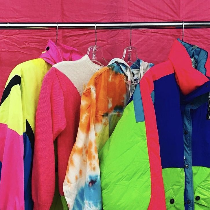 photo of rack of neon clothing