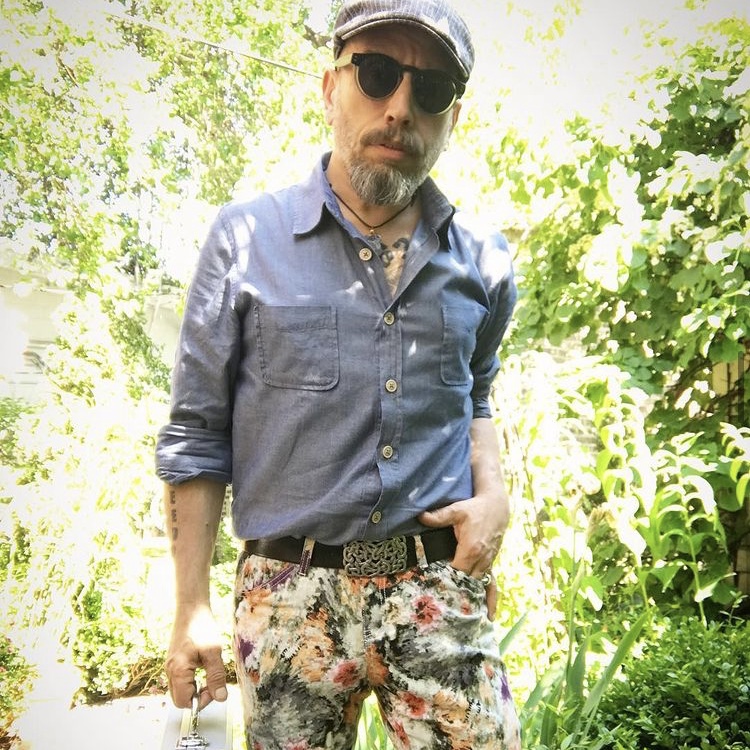 photo of man wearing floral pants