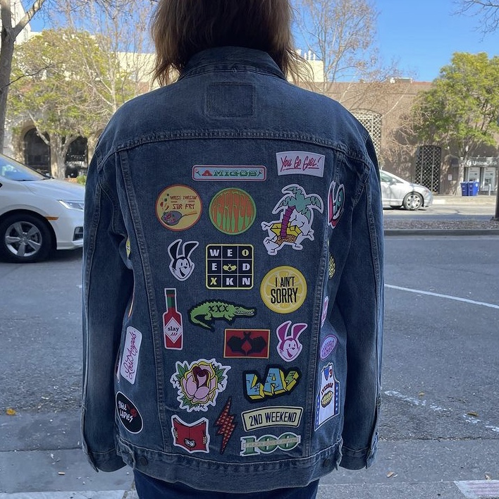 photo of woman in jean jacket with patches