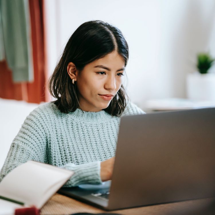 photo of woman looking at laptop