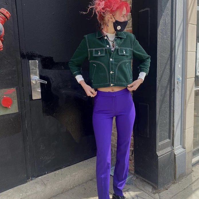 photo of woman in purple pants and green jacket