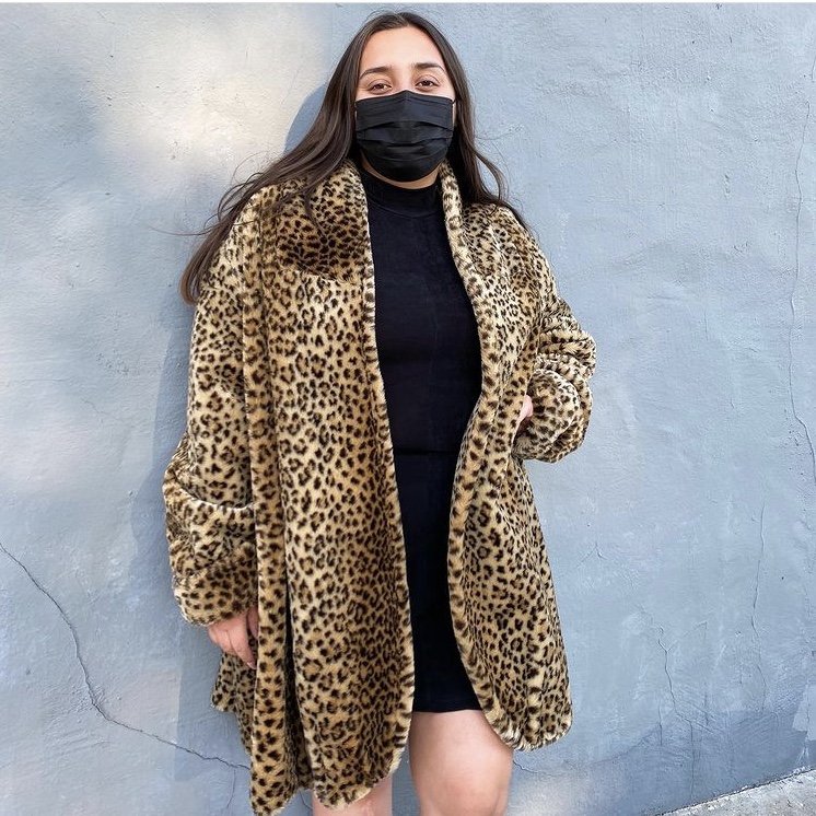 photo of person in faux fur leopard jacket