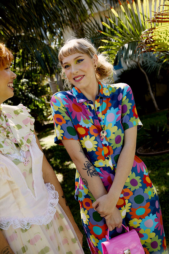 Katie smiling in a floral jumpsuit