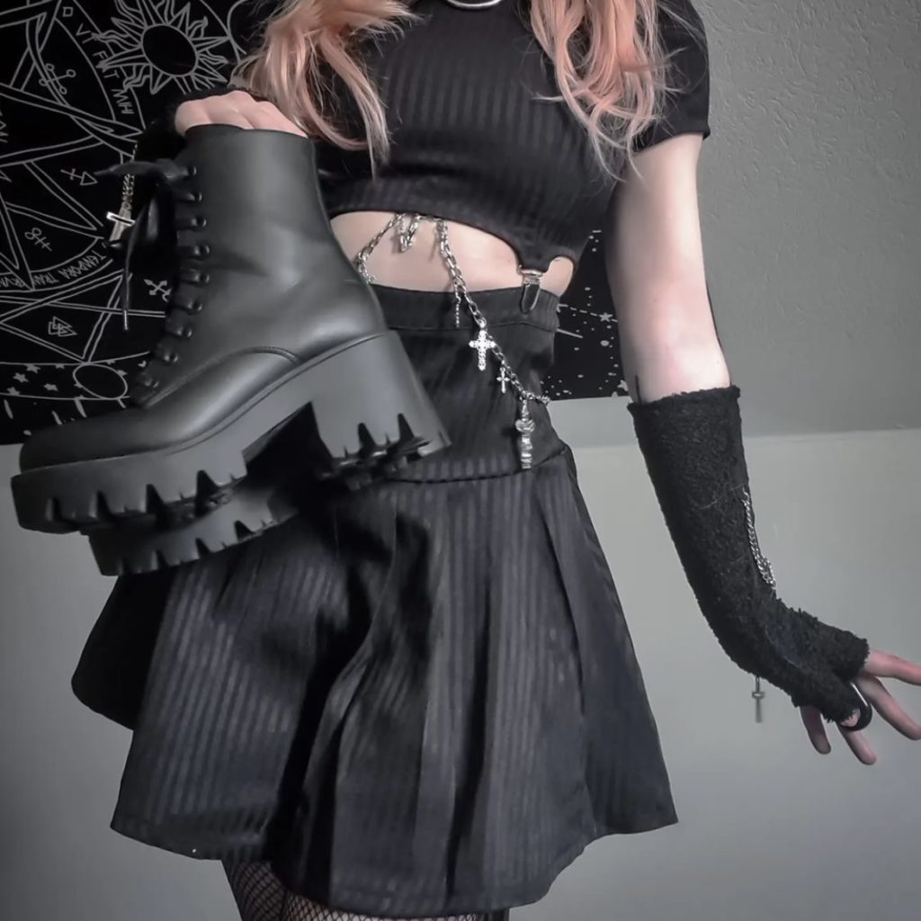Person holding black combat boots