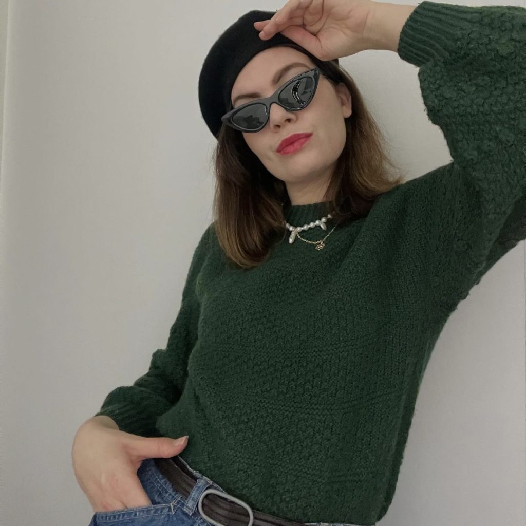 photo of person in green bell-sleeve sweater