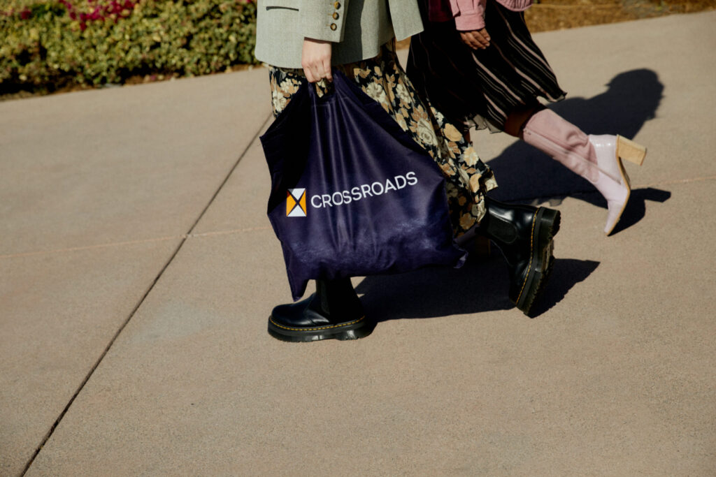 people carrying a Crossroads Trading bag