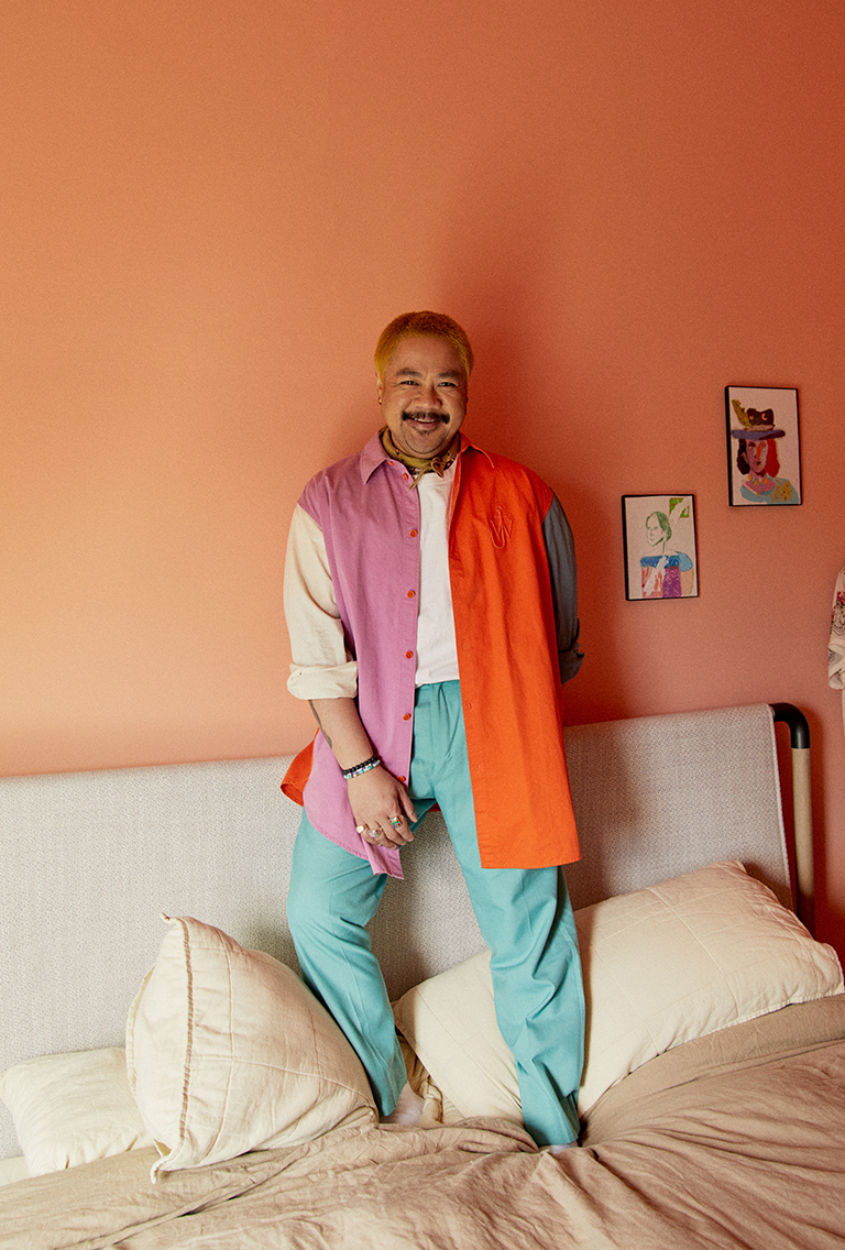 Model wearing summer clothing standing on the bed