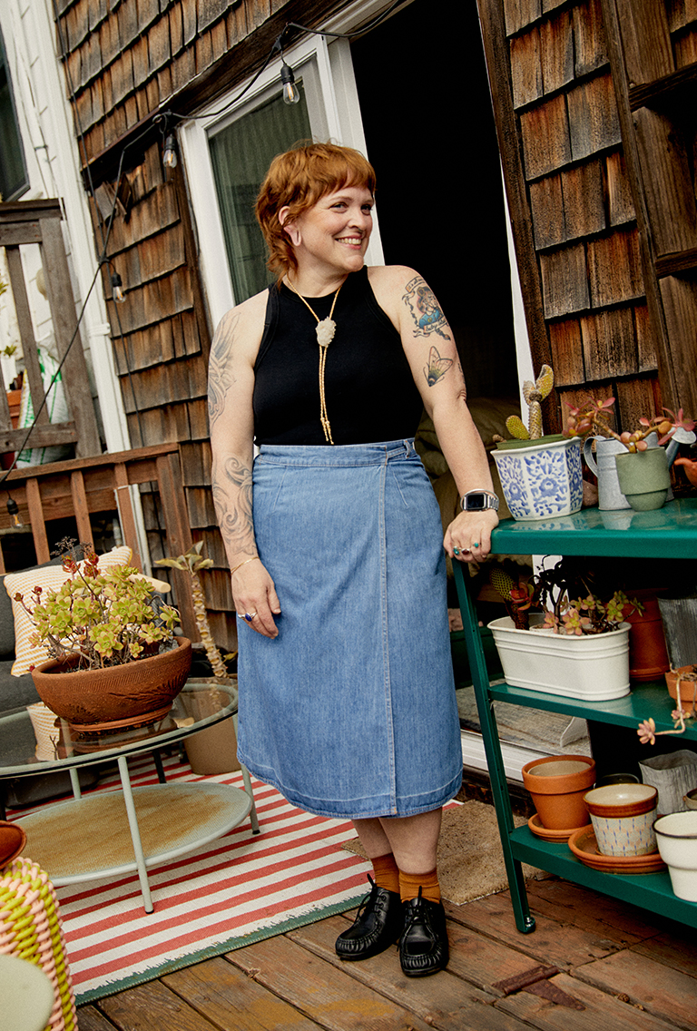 Model wearing a denim maxi skirt and a bolo tie