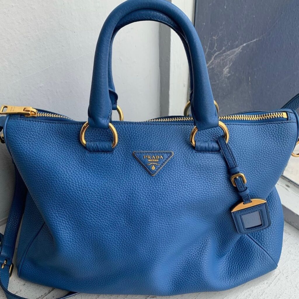 photo of a blue leather Prada handbag, one of the best used designer handbags