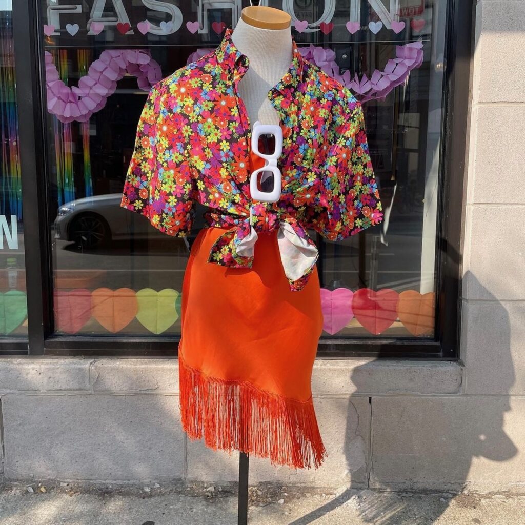 photo of a flowered blouse and fringed orange skirt 