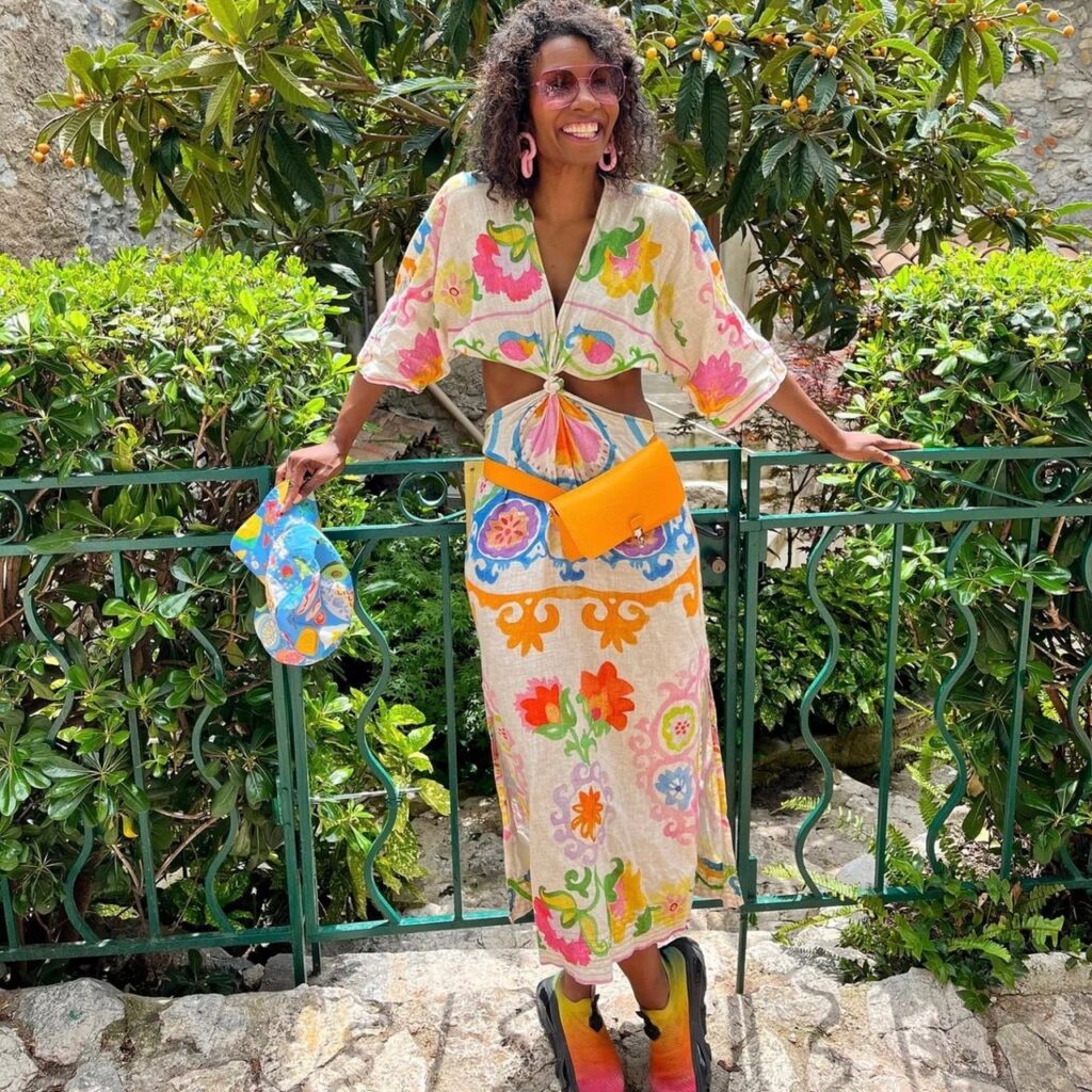 photo of person in a tropical print linen dress