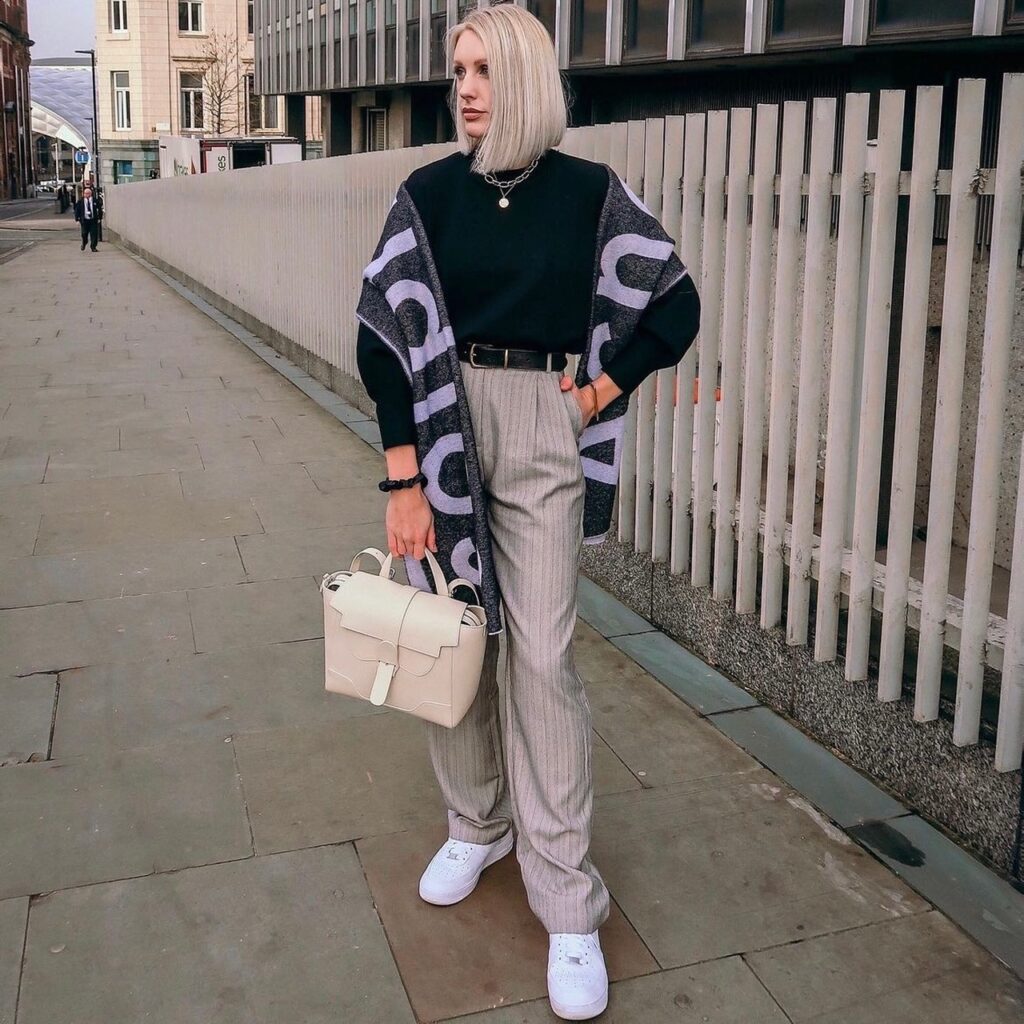 photo of person wearing pinstriped wide leg trousers and black turtleneck