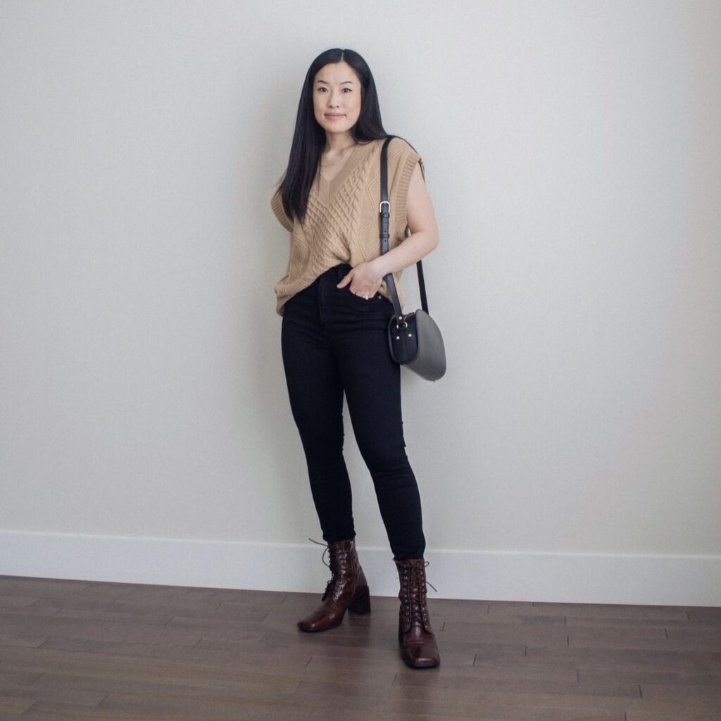 photo of person in tan top and black pants with boots