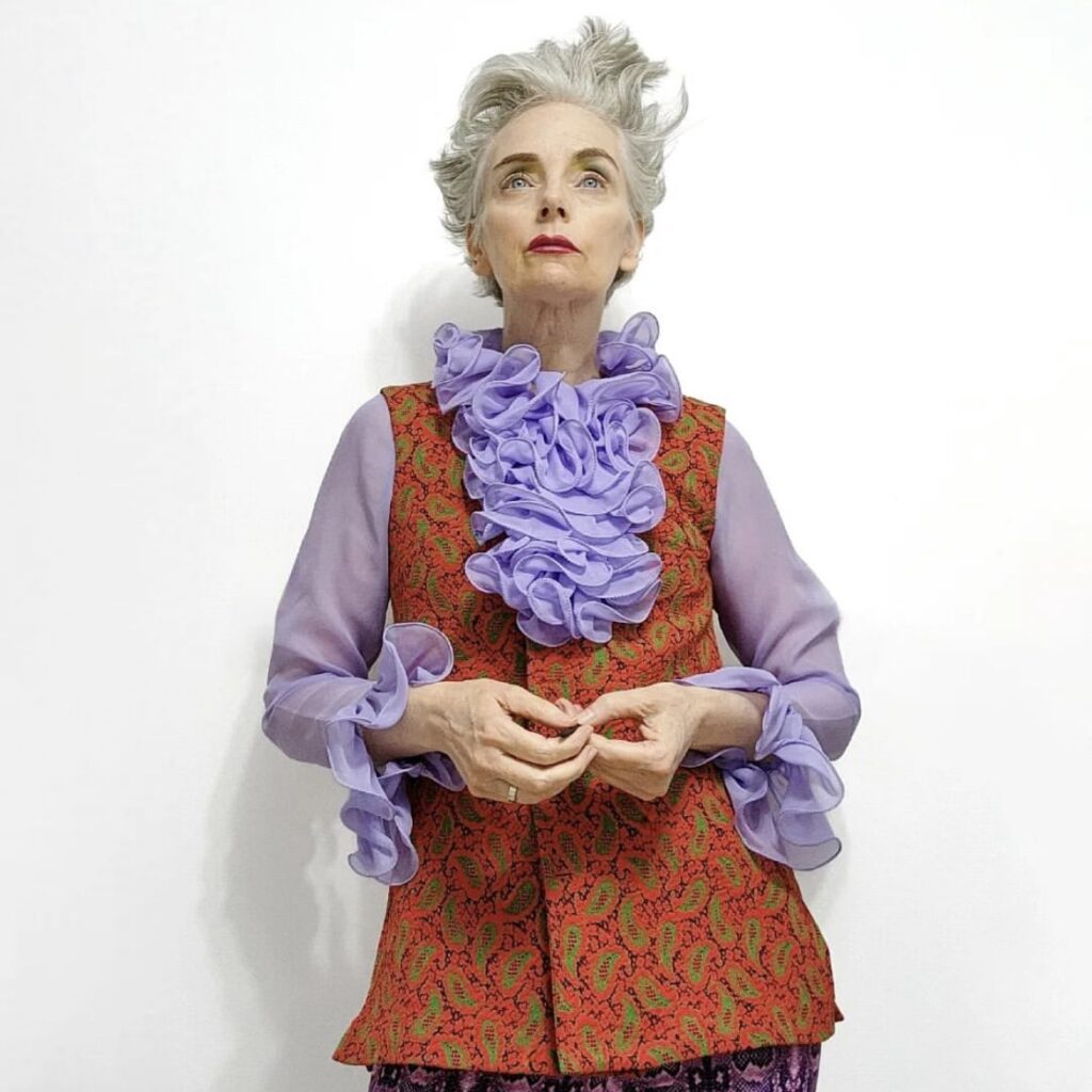 photo of woman in ruffled blouse and print vest
